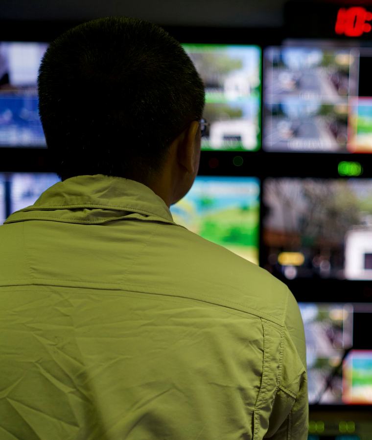 A specialist working across several screens