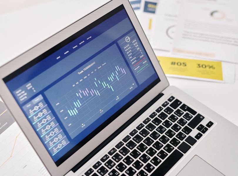 A laptop showing charts and analytics